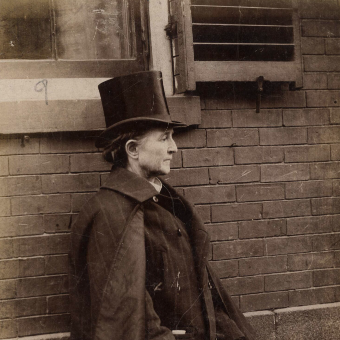 Dr. Mary Edwards Walker standing beside a wall