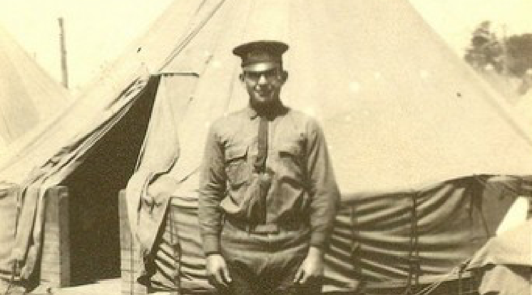 Man standing in front of tent.